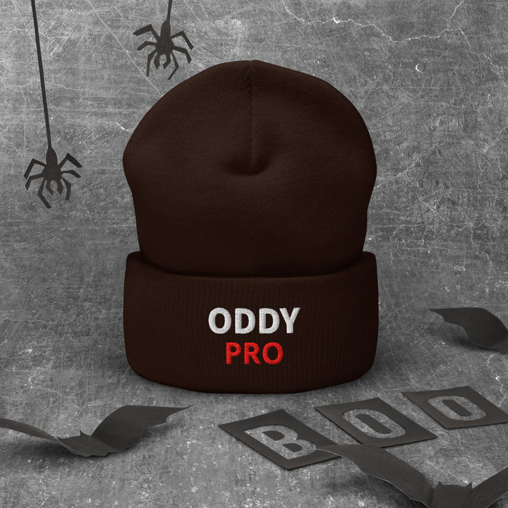 Oddy Pro cuffed beanie displayed on a textured background with Halloween-themed elements.