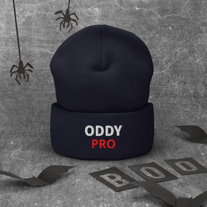 Oddy Pro cuffed beanie displayed on a textured background with Halloween-themed decor.