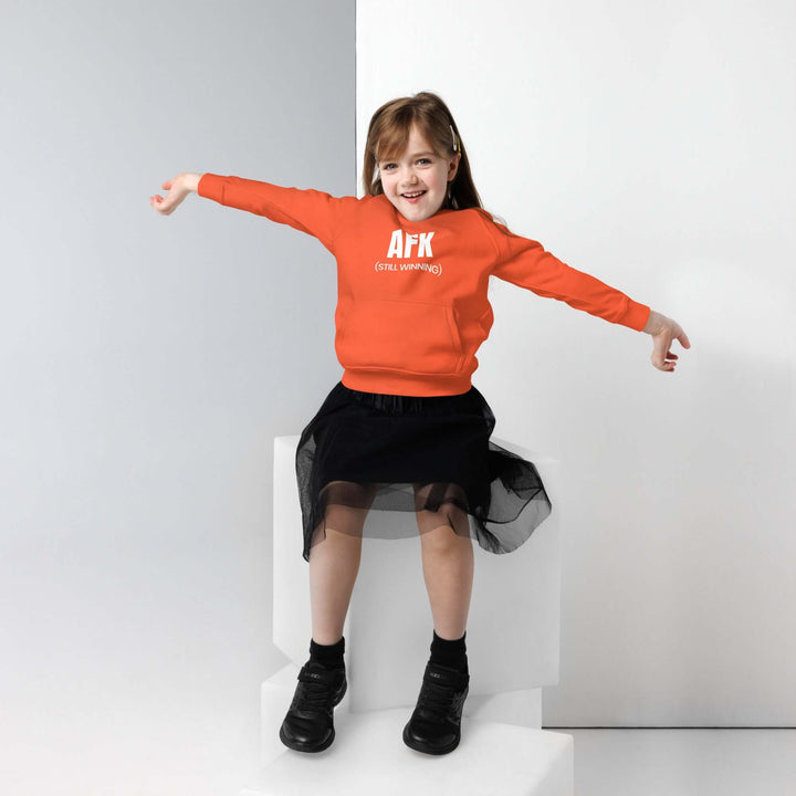 AFK Kids eco friendly hoodie featured on a young girl with orange sweatshirt and black skirt.