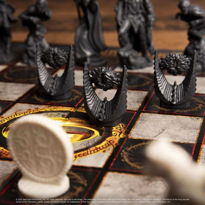 The Lord of the Rings - Battle For Middle Earth Chess Set featuring iconic black plastic pieces on a themed chessboard.