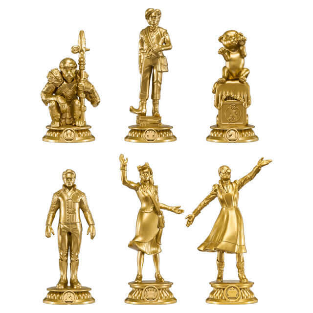 Wicked Chess Set featuring golden figures of Glinda, Elphaba, Fiyero, Boq, the Lion Cub, and Chistery.